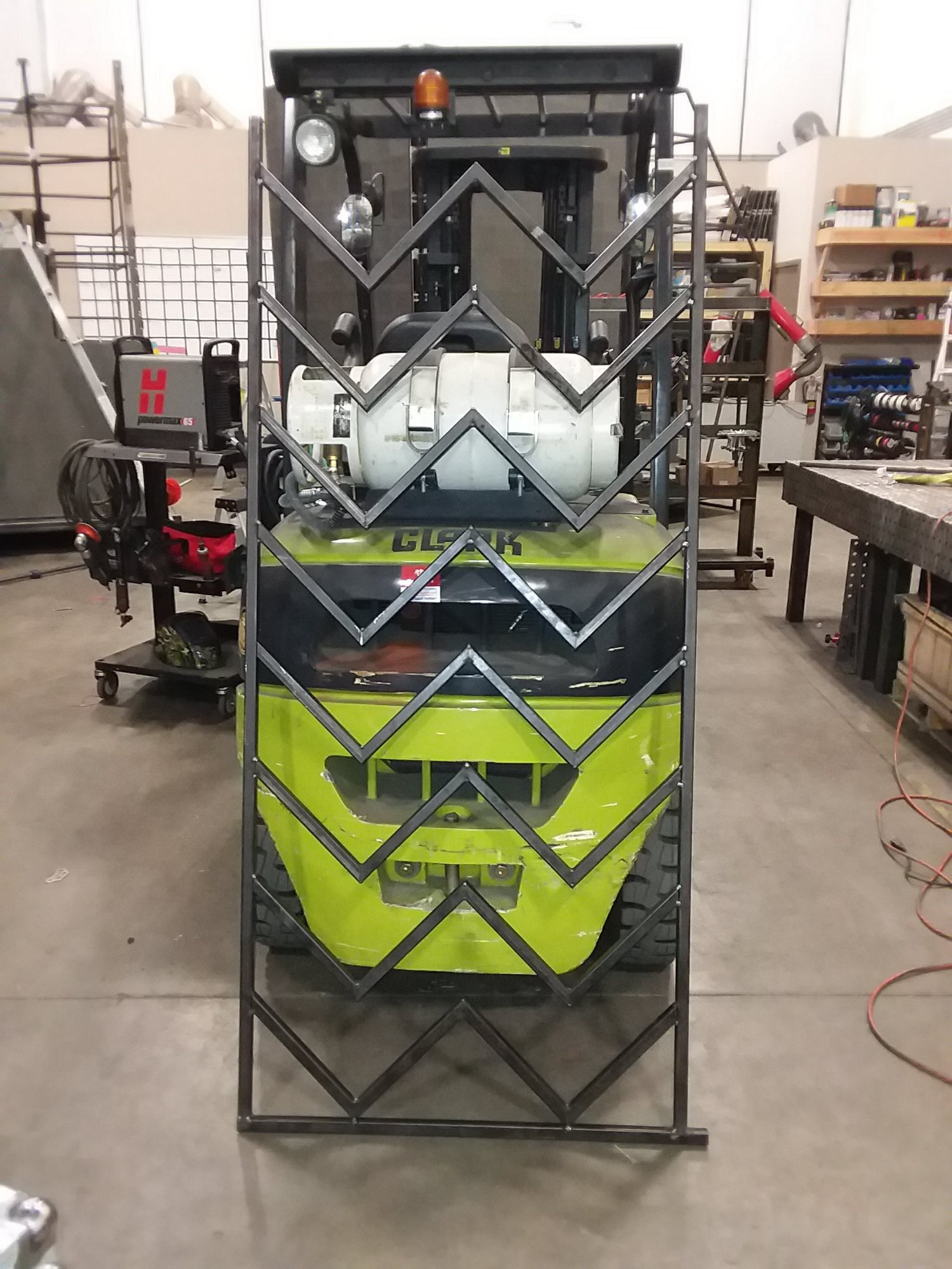 Custom chevron steel display frame — fabrication in progress